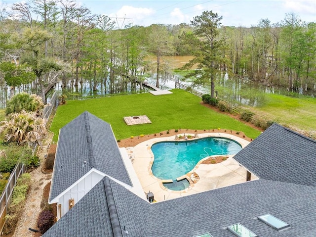 view of pool with a patio area, a pool with connected hot tub, and a water view