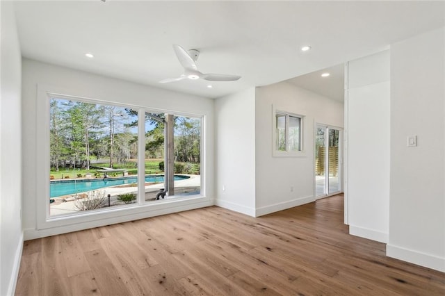 spare room featuring baseboards, wood finished floors, recessed lighting, and ceiling fan