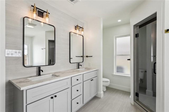 full bath with toilet, baseboards, wood finished floors, double vanity, and recessed lighting