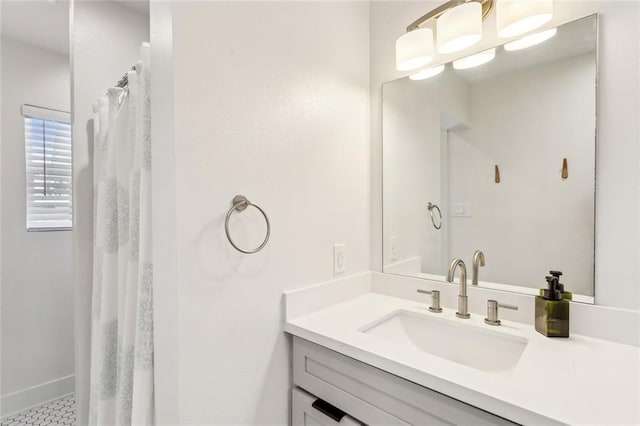 bathroom with vanity, a shower with curtain, and baseboards