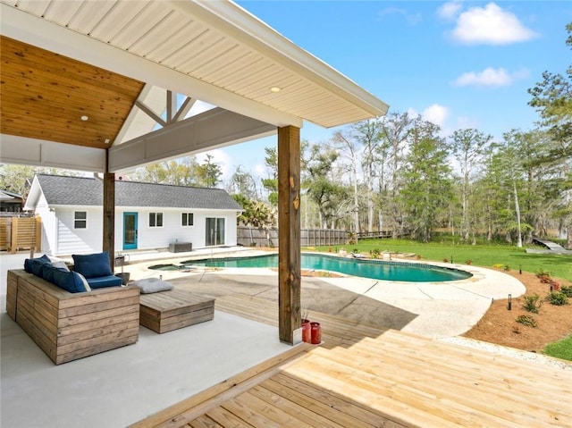 outdoor pool with a wooden deck and a patio area