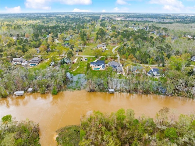 aerial view of property's location with a large body of water and nearby suburban area