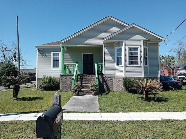 4800 Eastview Dr, New Orleans, LA 70126 - view of front of property featuring covered porch and a front lawn