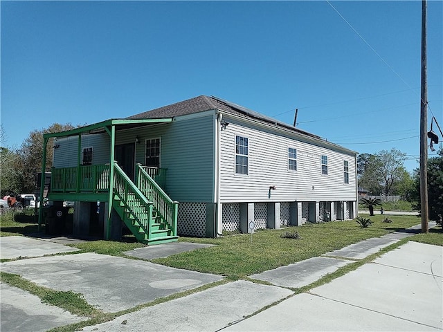 4800 Eastview Dr, New Orleans, LA 70126 - view of home's exterior with covered porch, stairway, and a yard