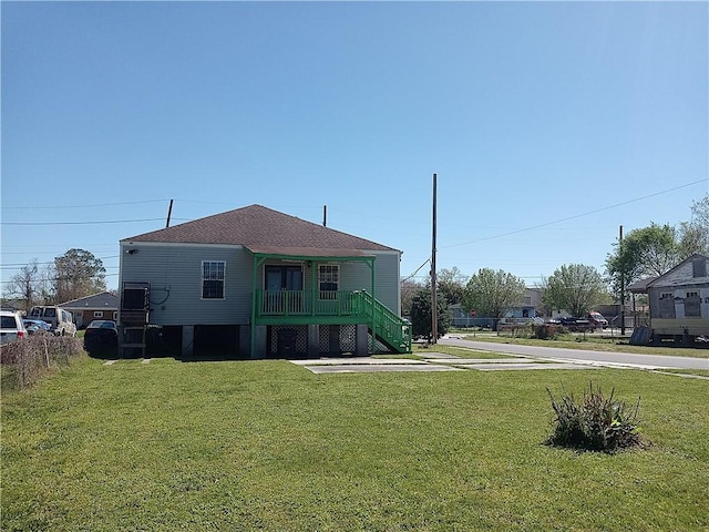 4800 Eastview Dr, New Orleans, LA 70126 - view of front of home with a porch, a shingled roof, stairway, and a front yard