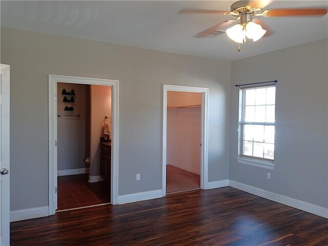 4800 Eastview Dr, New Orleans, LA 70126 - unfurnished bedroom featuring baseboards, a closet, a walk in closet, and dark wood-type flooring
