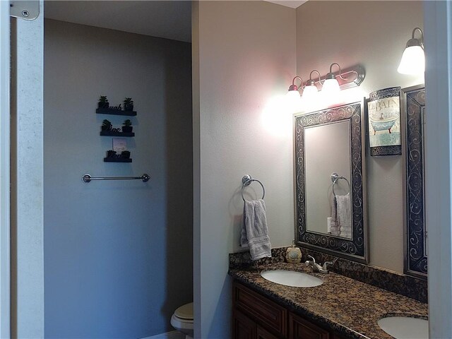 4800 Eastview Dr, New Orleans, LA 70126 - bathroom with toilet, a sink, and double vanity