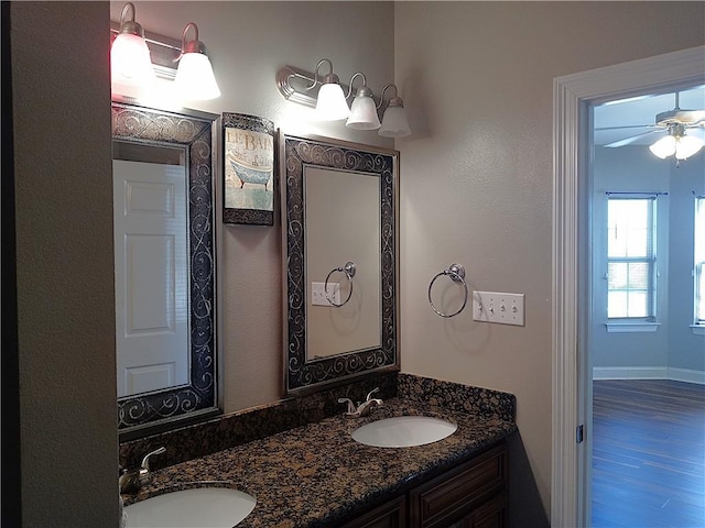4800 Eastview Dr, New Orleans, LA 70126 - bathroom with double vanity, a sink, a ceiling fan, and wood finished floors