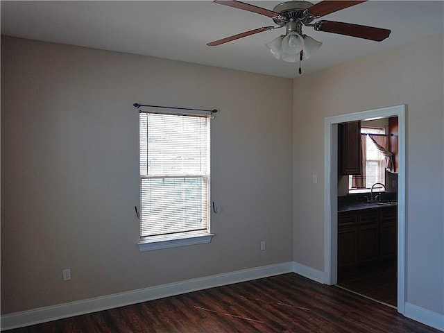 4800 Eastview Dr, New Orleans, LA 70126 - empty room featuring dark wood finished floors, baseboards, ceiling fan, and a sink