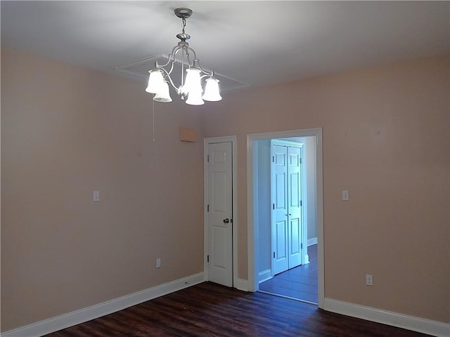 4800 Eastview Dr, New Orleans, LA 70126 - unfurnished room with baseboards, dark wood-type flooring, and an inviting chandelier