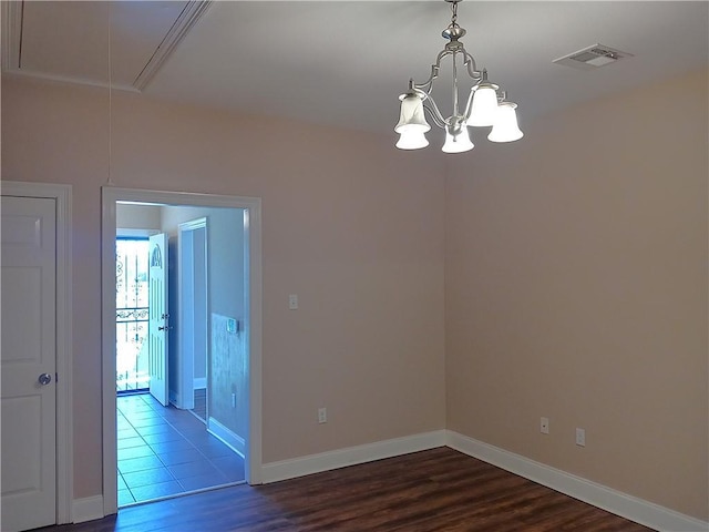 4800 Eastview Dr, New Orleans, LA 70126 - spare room with attic access, visible vents, a chandelier, and dark wood-style flooring