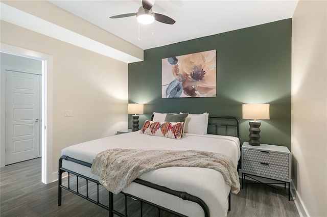 bedroom featuring a ceiling fan, wood finished floors, and baseboards