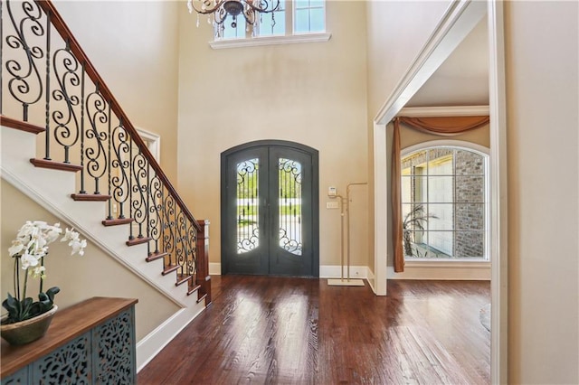 192 Forest Oaks Dr, New Orleans, LA 70131 - foyer with stairs, hardwood / wood-style floors, french doors, arched walkways, and a notable chandelier