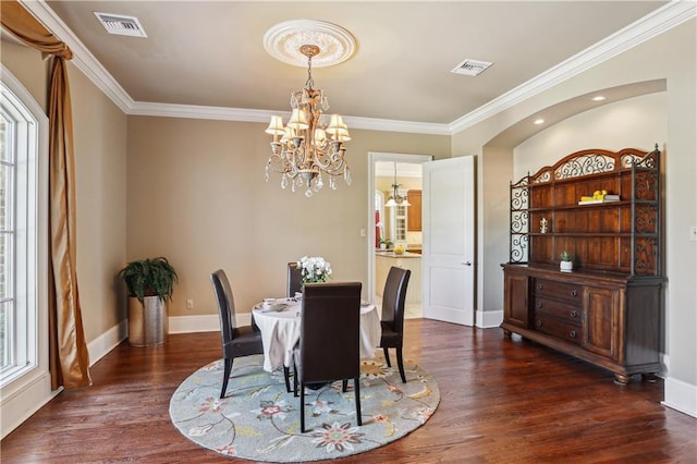 192 Forest Oaks Dr, New Orleans, LA 70131 - dining space featuring visible vents, dark wood finished floors, an inviting chandelier, crown molding, and baseboards