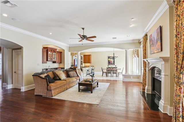192 Forest Oaks Dr, New Orleans, LA 70131 - living area with wood finished floors, arched walkways, visible vents, and ornate columns