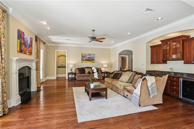192 Forest Oaks Dr, New Orleans, LA 70131 - living area with a ceiling fan, beverage cooler, dark wood-style flooring, ornamental molding, and indoor wet bar