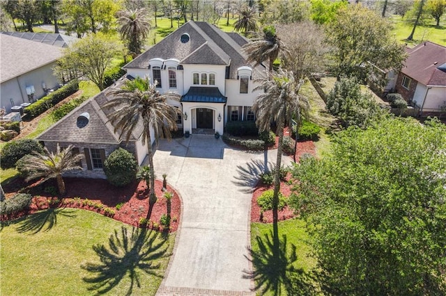 192 Forest Oaks Dr, New Orleans, LA 70131 - view of front facade featuring concrete driveway, a garage, a front yard, and stucco siding