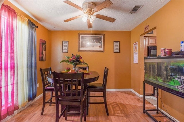1504 Kings Row, Slidell, LA 70461 - dining area featuring healthy amount of natural light, light wood-style floors, ceiling fan, and a textured ceiling