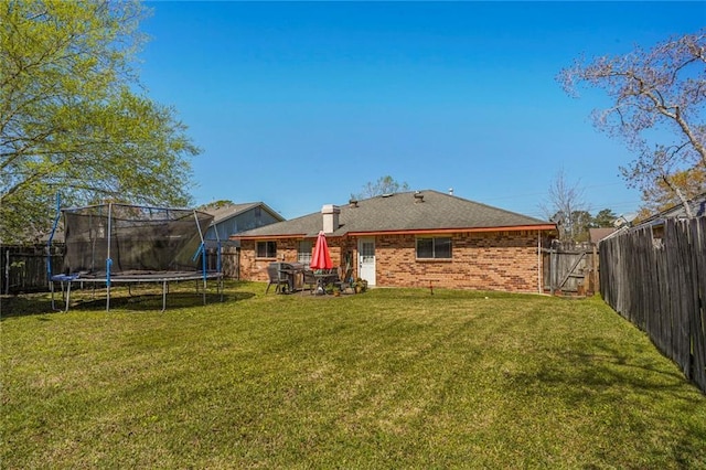 1504 Kings Row, Slidell, LA 70461 - back of house with a trampoline and brick siding