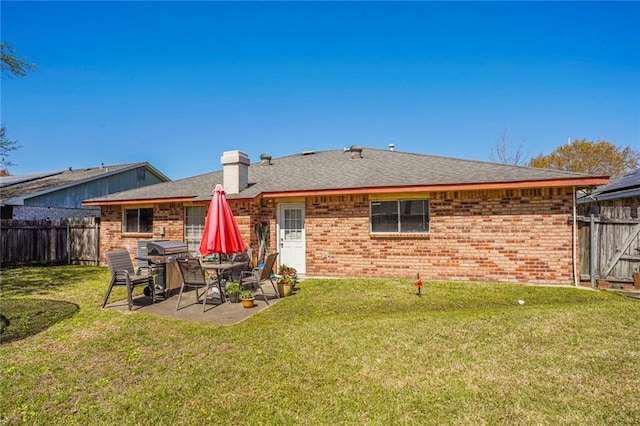 1504 Kings Row, Slidell, LA 70461 - rear view of house featuring brick siding, a patio area, a chimney, and roof with shingles