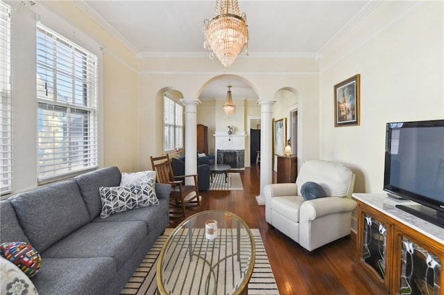 1930 N Rampart St, New Orleans, LA 70116 - living area featuring ornate columns, arched walkways, wood finished floors, a chandelier, and ornamental molding