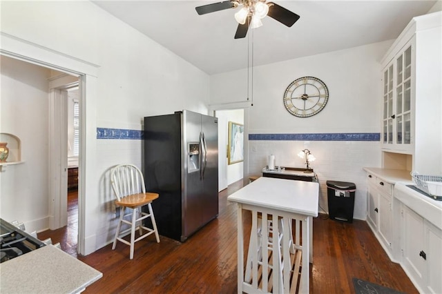 1930 N Rampart St, New Orleans, LA 70116 - kitchen with stainless steel fridge with ice dispenser, a ceiling fan, glass insert cabinets, a wainscoted wall, and tile walls