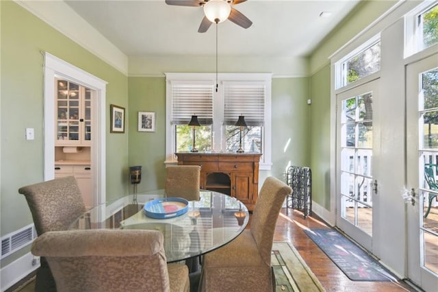 1930 N Rampart St, New Orleans, LA 70116 - dining room featuring wood finished floors, a ceiling fan, and baseboards