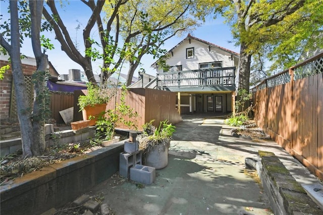 1930 N Rampart St, New Orleans, LA 70116 - rear view of house with a deck, a fenced backyard, a patio area, and concrete driveway