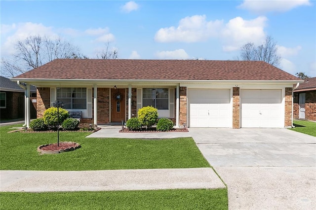 ranch-style home featuring a garage, driveway, brick siding, and a front lawn