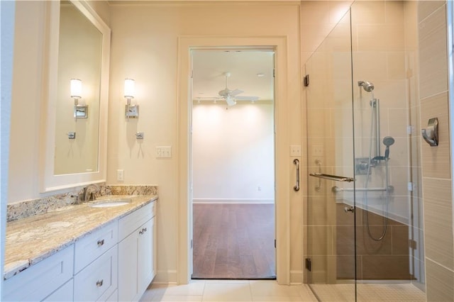 989 Beauregard Pkwy, Covington, LA 70433 - full bath featuring ceiling fan, tile patterned flooring, vanity, baseboards, and a shower stall