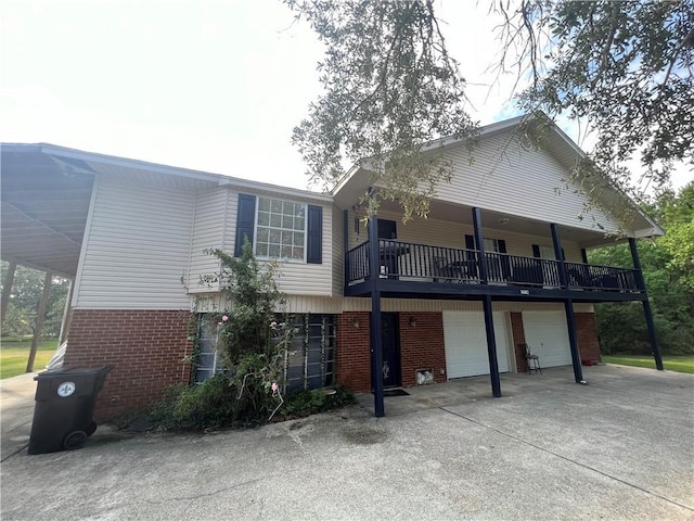 34062 Laurent Rd, Slidell, LA 70460 - view of front of home with brick siding, a garage, and concrete driveway
