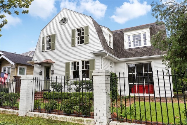 303 Audubon St, New Orleans, LA 70118 - colonial inspired home with roof with shingles and a gambrel roof