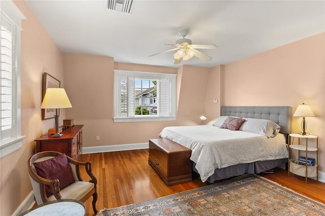 303 Audubon St, New Orleans, LA 70118 - bedroom with wood finished floors, baseboards, and ceiling fan