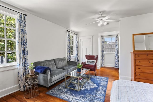 303 Audubon St, New Orleans, LA 70118 - living room featuring wood finished floors, baseboards, and a ceiling fan