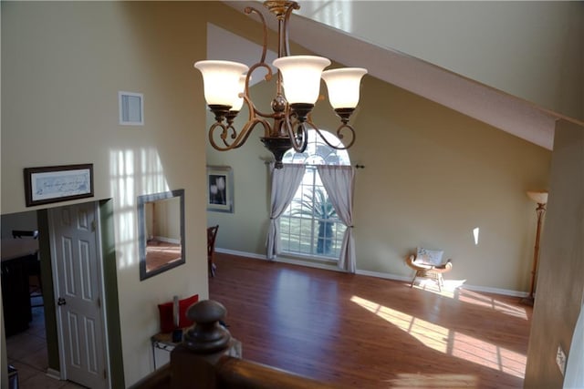 115 Silverwood Dr, Slidell, LA 70461 - dining area with high vaulted ceiling, visible vents, baseboards, wood finished floors, and an inviting chandelier