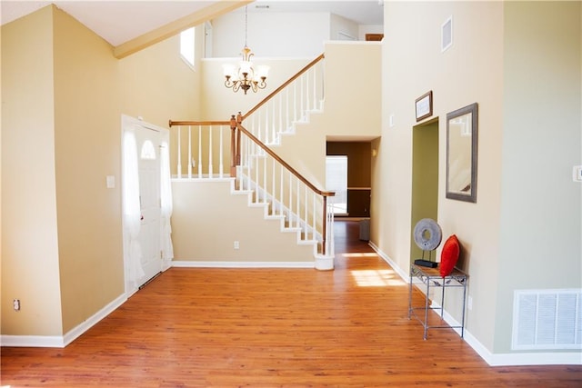 115 Silverwood Dr, Slidell, LA 70461 - entrance foyer featuring visible vents, wood finished floors, stairway, and an inviting chandelier