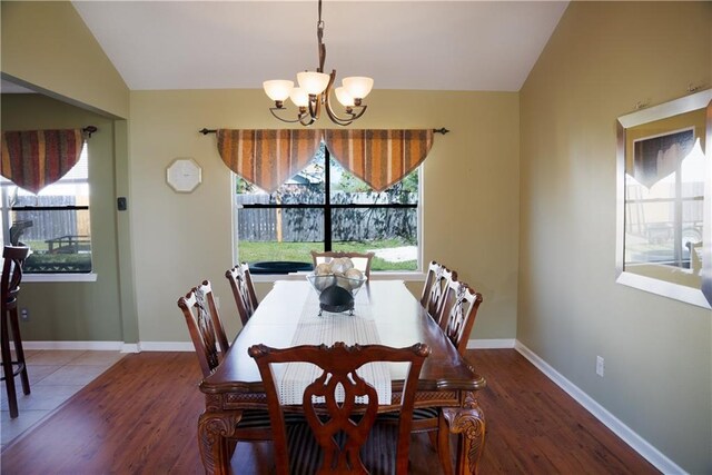115 Silverwood Dr, Slidell, LA 70461 - dining space featuring baseboards, lofted ceiling, a chandelier, and wood finished floors