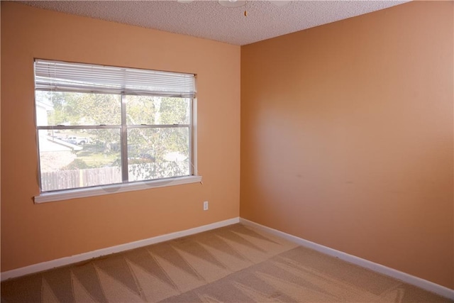 115 Silverwood Dr, Slidell, LA 70461 - spare room featuring light carpet, baseboards, and a textured ceiling