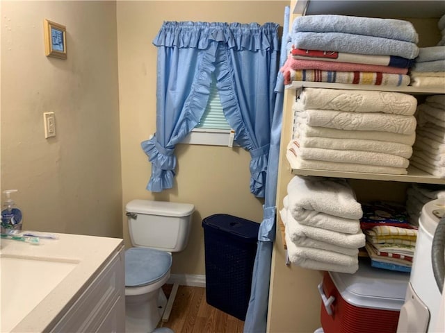 50507 N Salcedo St, New Orleans, LA 70119 - bathroom with toilet, wood finished floors, baseboards, and a sink