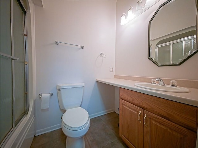 bathroom featuring vanity, toilet, baseboards, bath / shower combo with glass door, and tile patterned floors