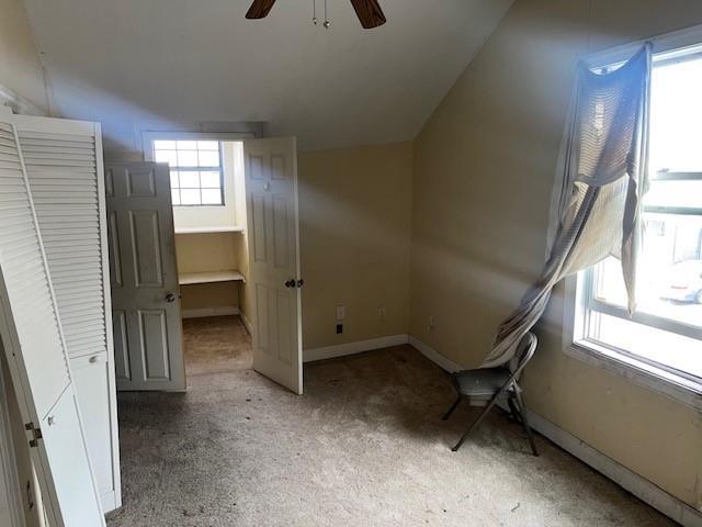 3801 Tchoupitoulas St, New Orleans, LA 70115 - interior space featuring baseboards, ceiling fan, light colored carpet, and vaulted ceiling