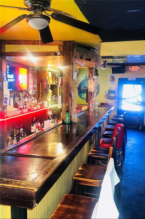 3801 Tchoupitoulas St, New Orleans, LA 70115 - bar featuring a bar, carpet, and a ceiling fan