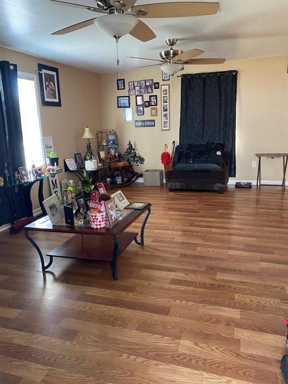 2547 Athis St, New Orleans, LA 70122 - living area with wood finished floors, ceiling fan, and baseboards
