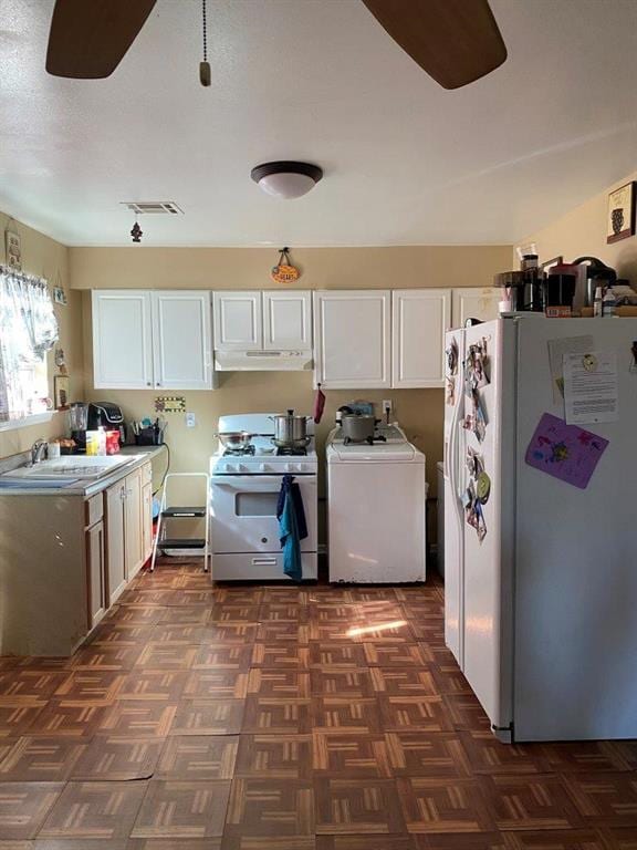 2547 Athis St, New Orleans, LA 70122 - kitchen with washer / dryer, white appliances, a ceiling fan, and white cabinets