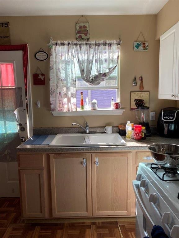 2547 Athis St, New Orleans, LA 70122 - kitchen featuring a sink, gas range, and plenty of natural light