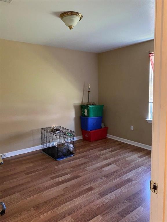 2547 Athis St, New Orleans, LA 70122 - spare room featuring wood finished floors and baseboards