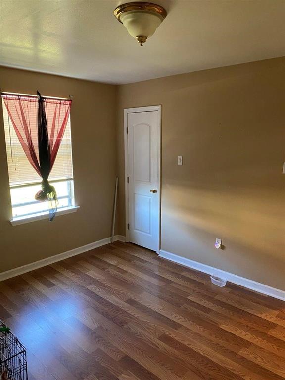 2547 Athis St, New Orleans, LA 70122 - empty room with dark wood finished floors and baseboards