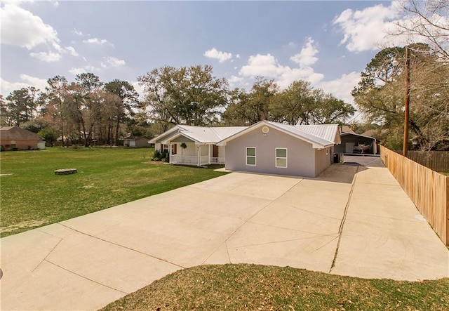 single story home with fence, concrete driveway, a front yard, stucco siding, and a carport