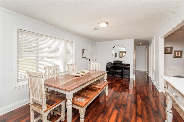 dining area with a textured ceiling, visible vents, crown molding, and dark wood finished floors