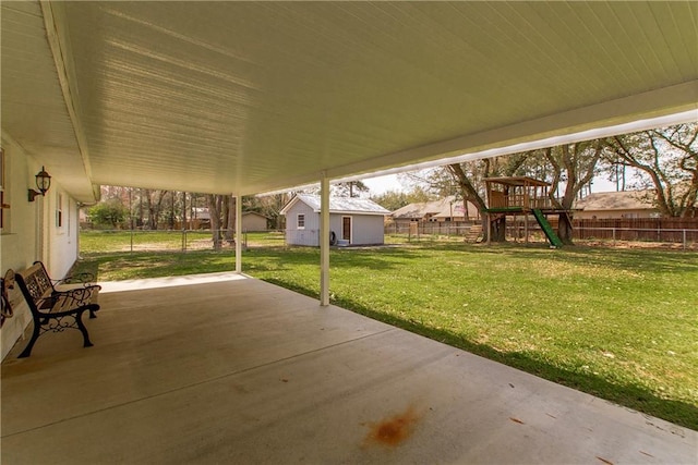 view of patio / terrace featuring fence and a playground